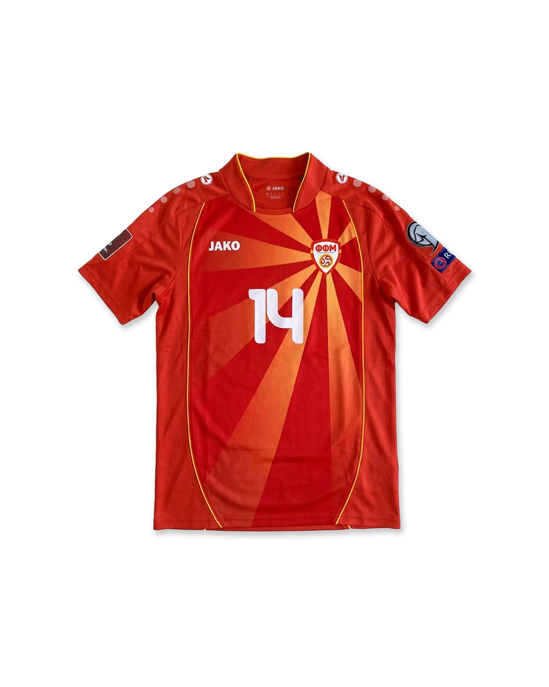 Red Macedonian football jersey with yellow sunburst design